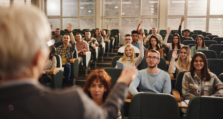 Speaker demonstrating stage presence by engaging with an audience during a presentation.